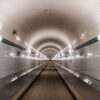 a subway station with a long line of subway tracks