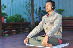 a man sitting on a table wearing headphones