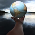 person holding clear glass ball